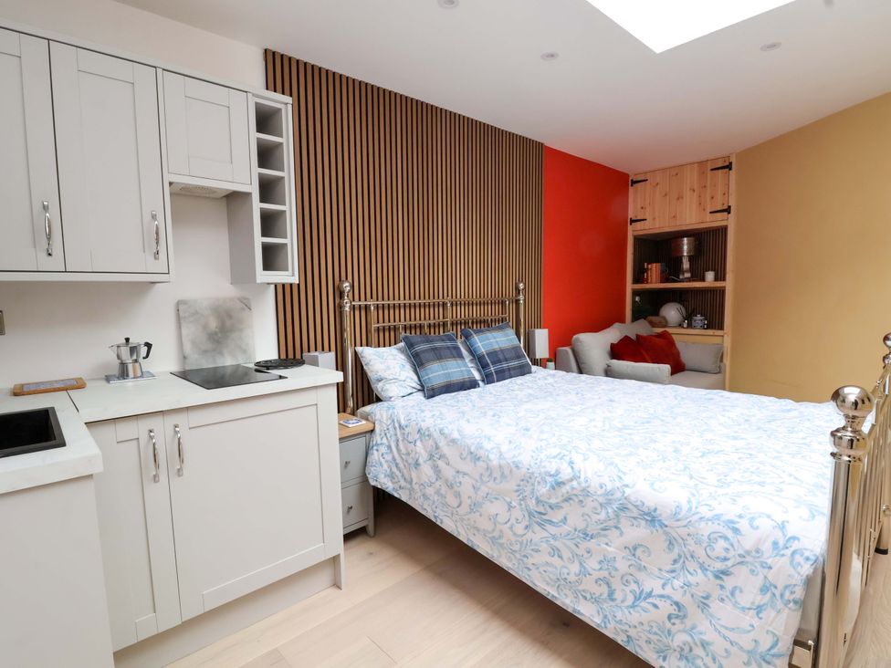 A bedroom with a bed and kitchenette at Skylights in Chester