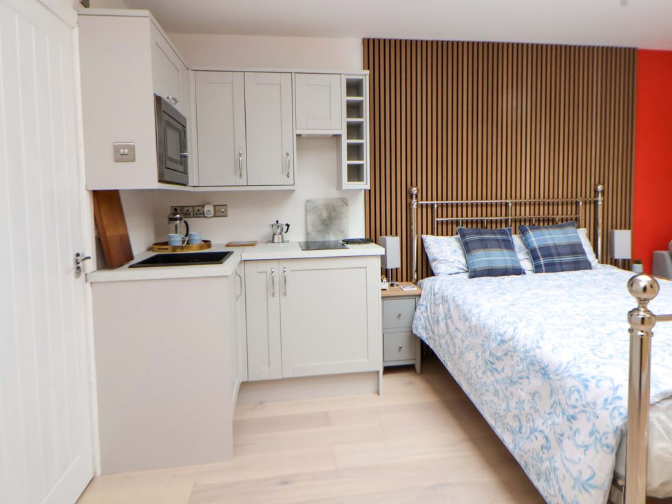 A bedroom with a kitchenette and bed at Skylights Chester