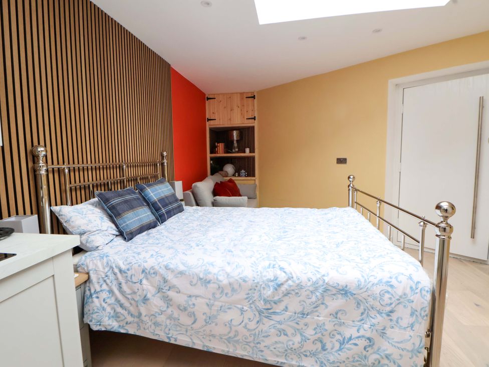 A bedroom with a bed and a sofa at Skylights in Chester