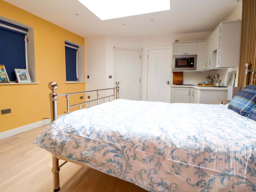 A bedroom with a bed and kitchenette at Skylights in Chester