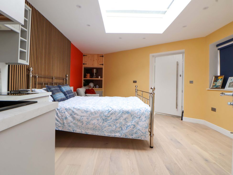 A bedroom with a bed and kitchen unit at Skylights in Chester