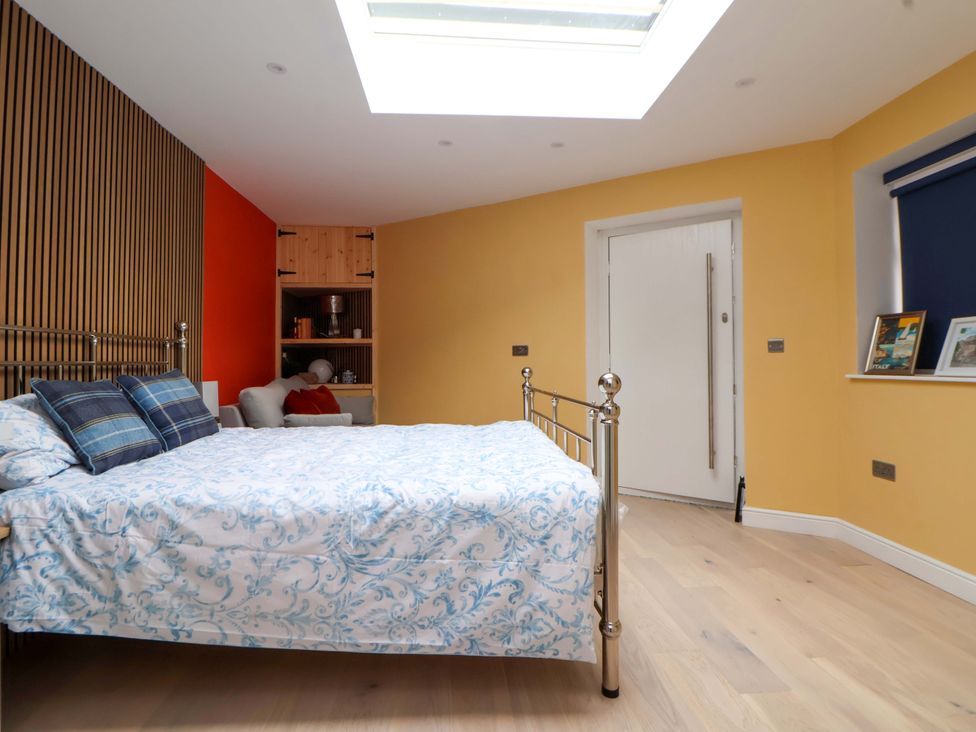 A bedroom with a bed and shelving at Skylights Chester
