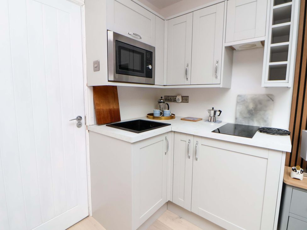 A kitchen with a microwave and sink at Skylights Chester