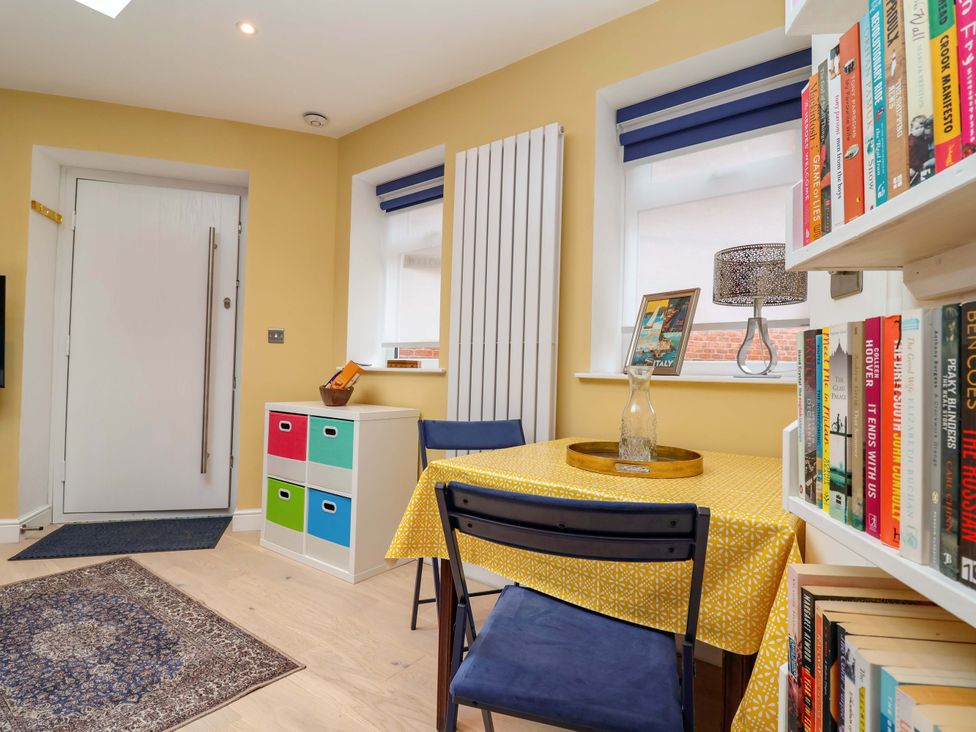 A dining room with a table and chairs at Skylights in Hoole