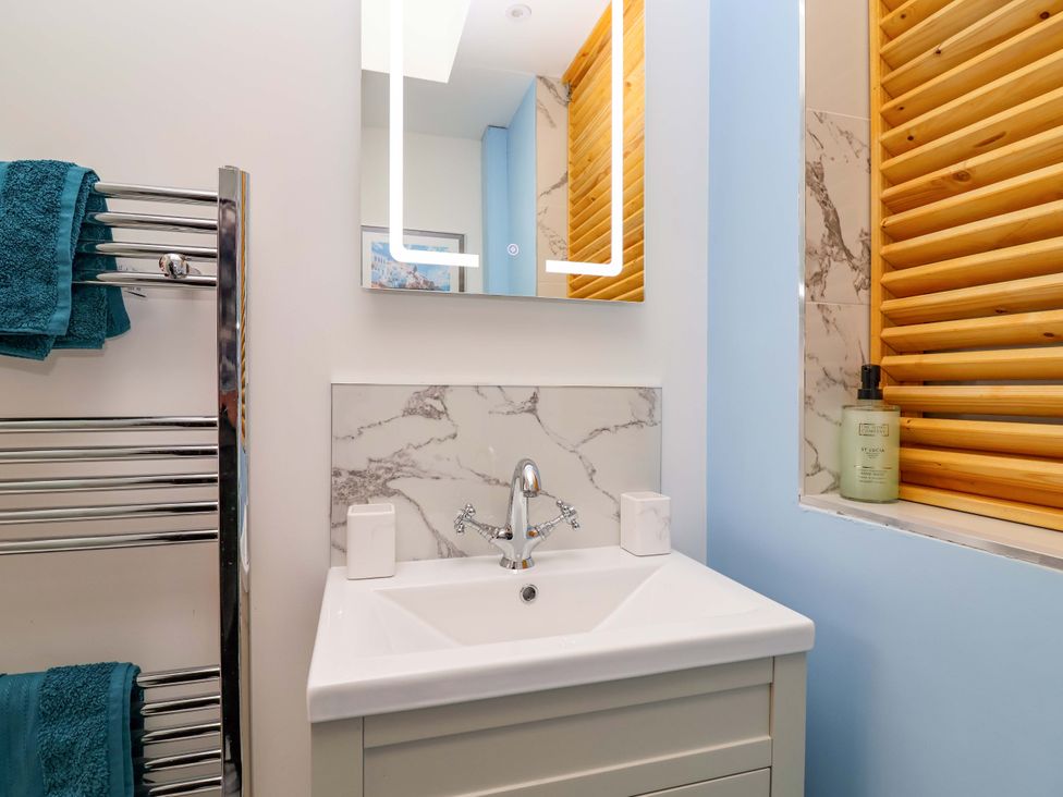 A bathroom with sink and towel rack at Skylights in Hoole