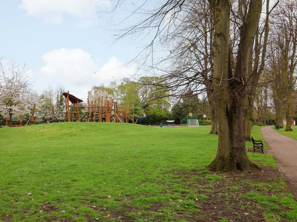 A playground with a slide and bench at Skylights in Hoole