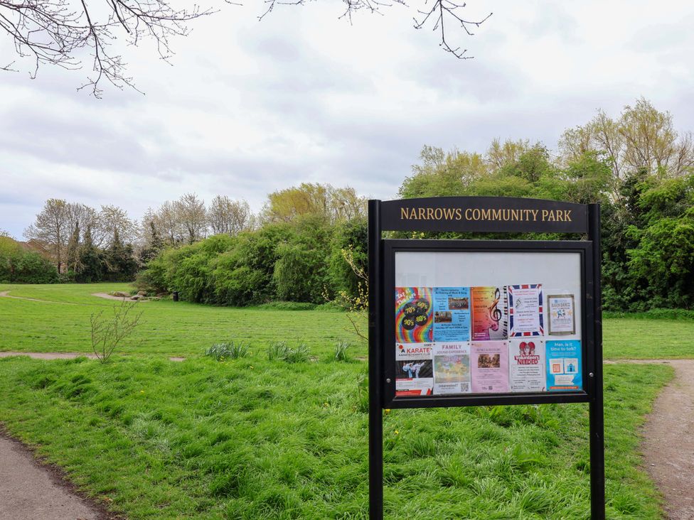 A signboard displaying community events in Narrows Community Park in urban area