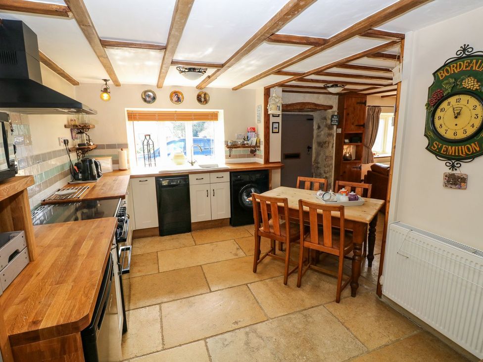 A kitchen with a table and chairs at 1 Mill Farm Cottages in Narberth