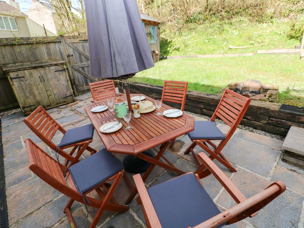 An outdoor dining area with a table and chairs at 1 Mill Farm Cottages in Narberth