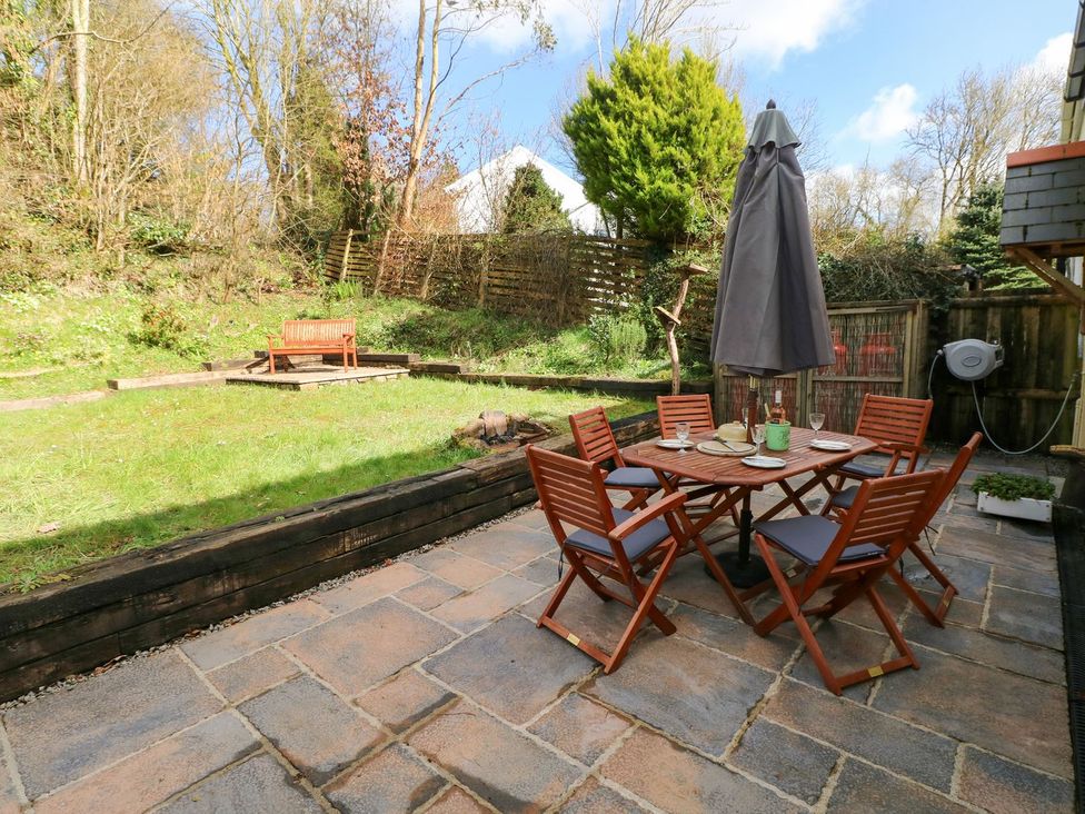 A garden with a table and chairs at 1 Mill Farm Cottages in Narberth