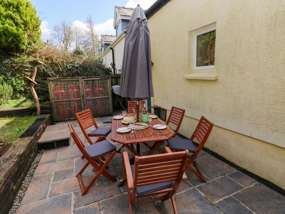 An outdoor dining area with a table and chairs at 1 Mill Farm Cottages Narberth