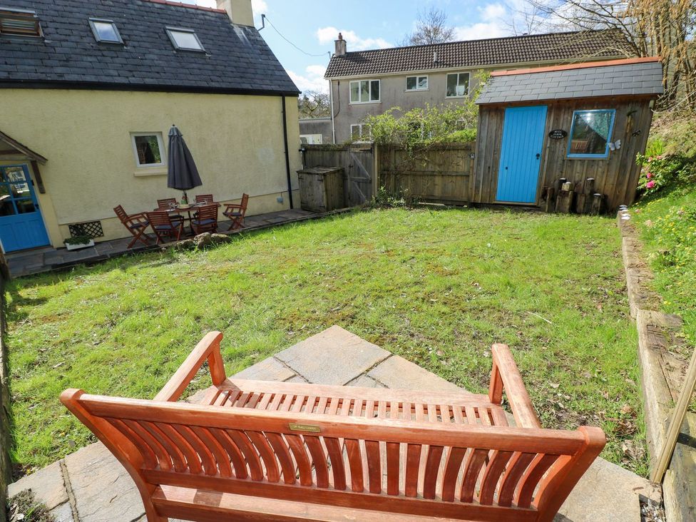 A garden with a table and chairs at 1 Mill Farm Cottages in Narberth