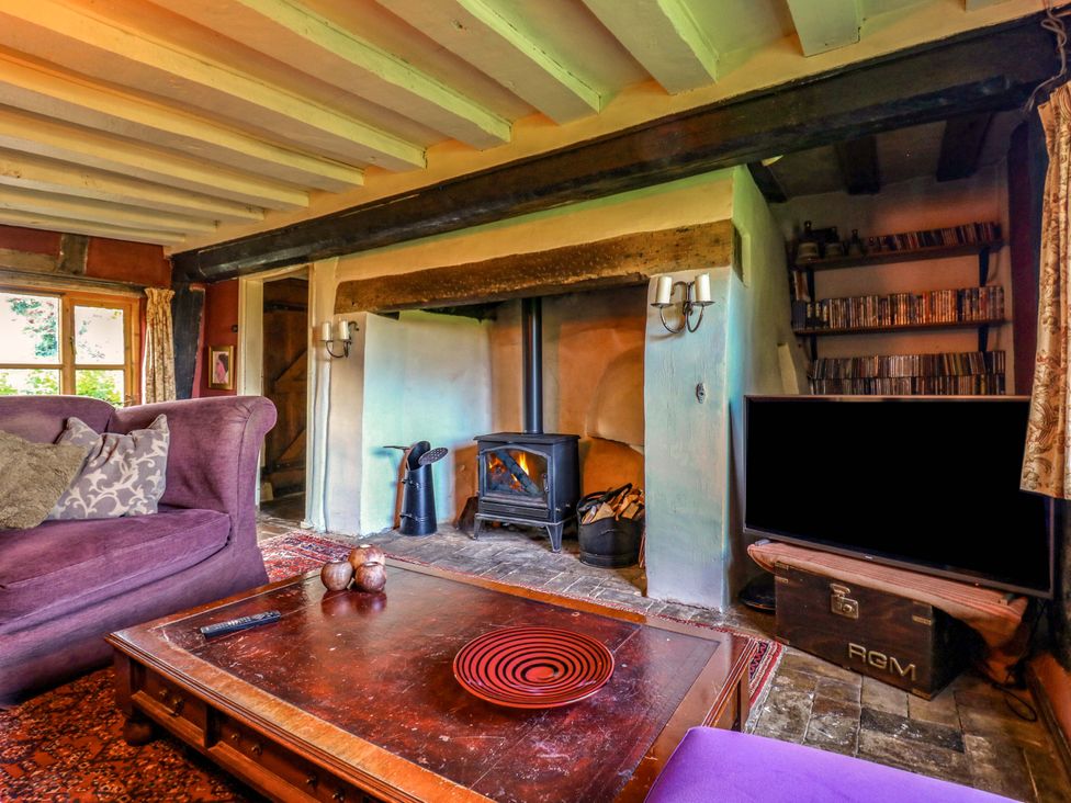 A living room with a fireplace and sofa at Town Farm