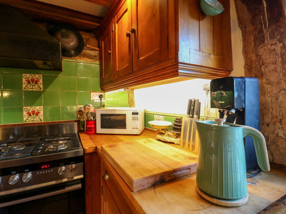 A kitchen with a stove, microwave, and kettle at Town Farm in 