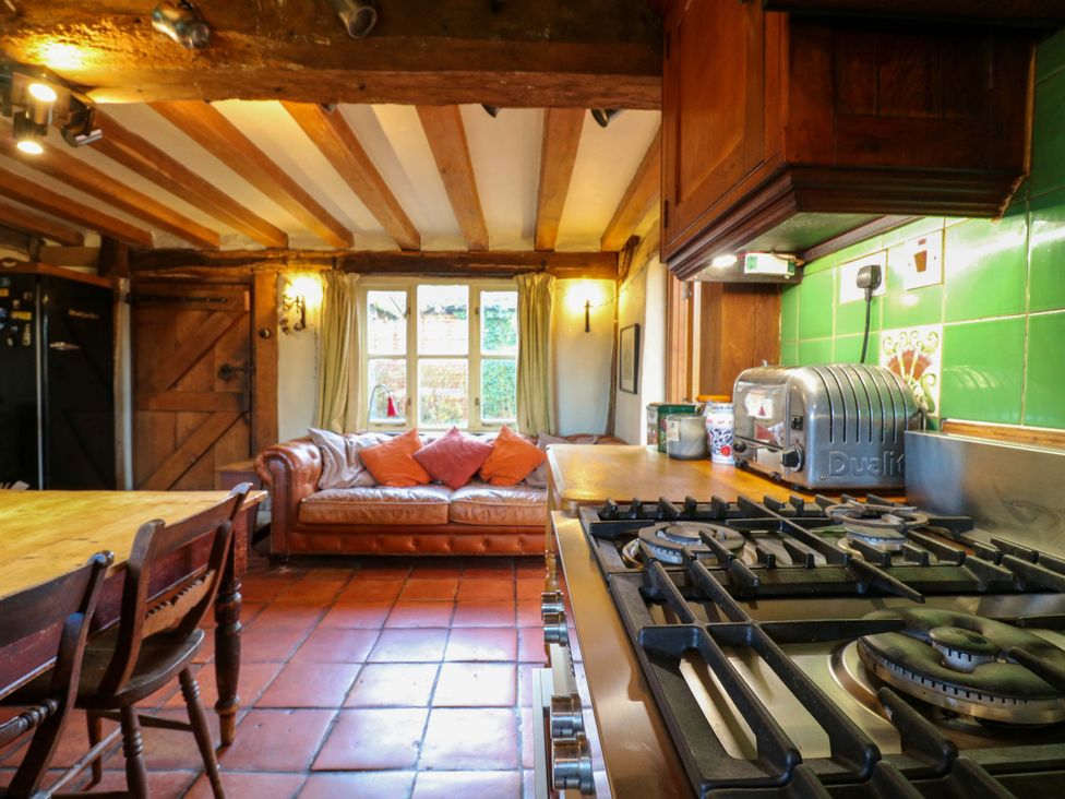 A kitchen with a stove and table at Town Farm