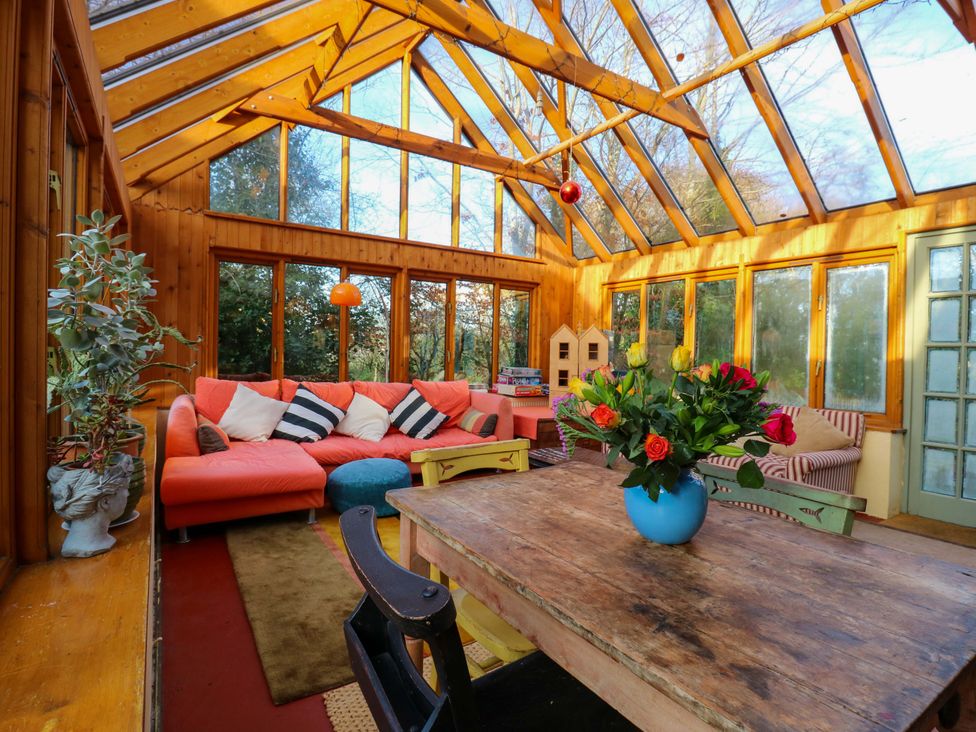 A conservatory with a large table and sofa at Town Farm in 