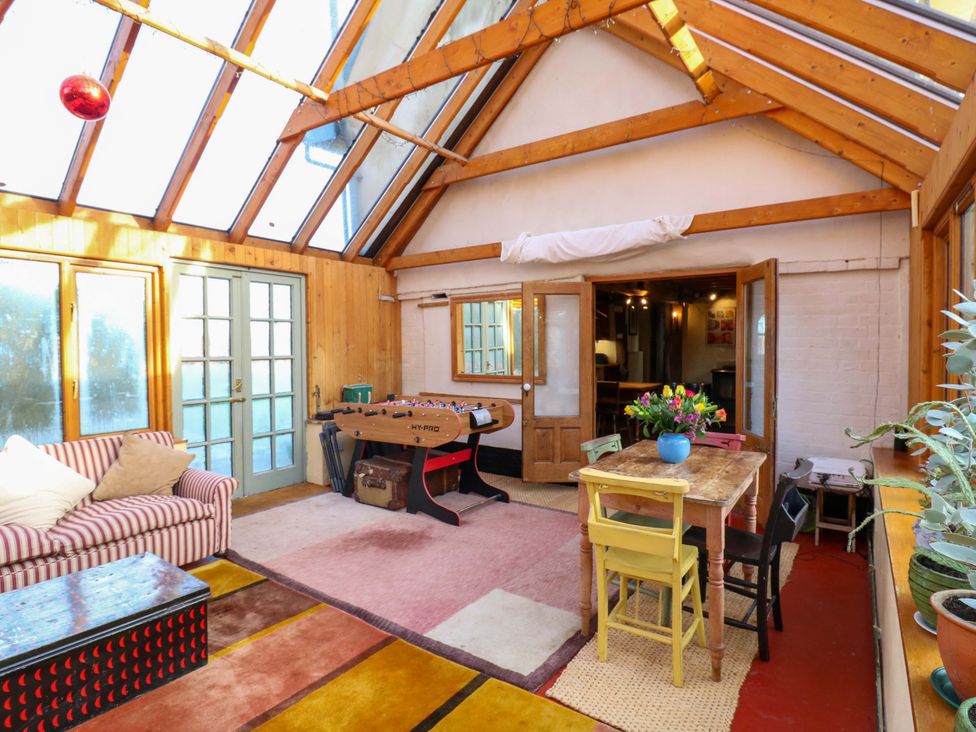 A conservatory with a foosball table and a dining set at Town Farm 