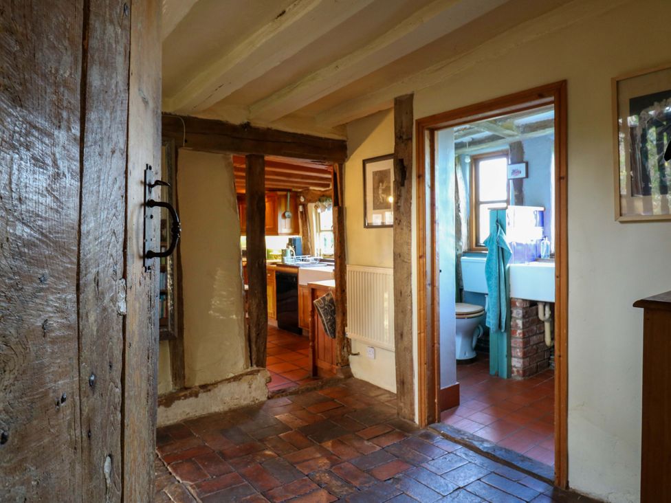 A hallway with a view of a kitchen and bathroom at Town Farm in 