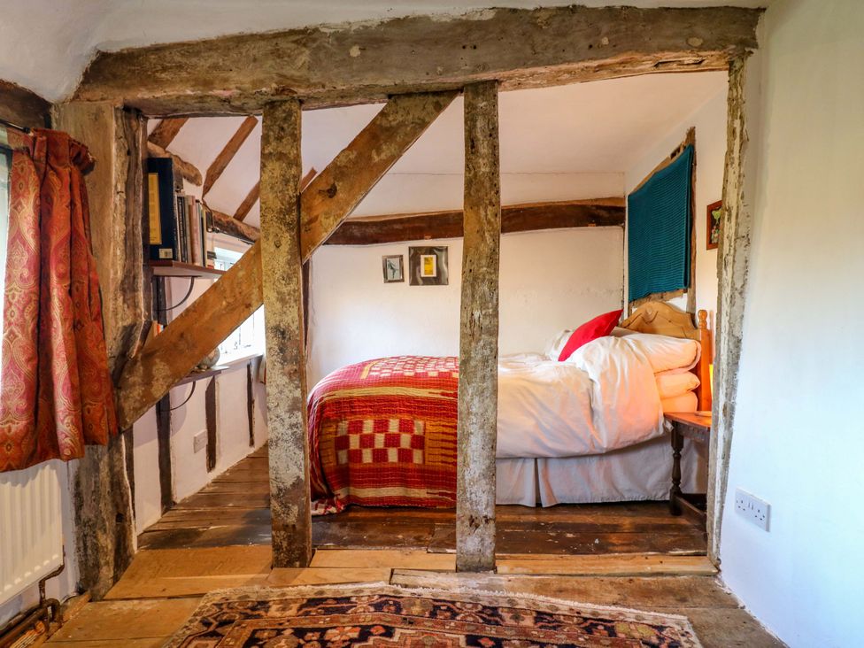 A bedroom with a bed and shelves at Town Farm
