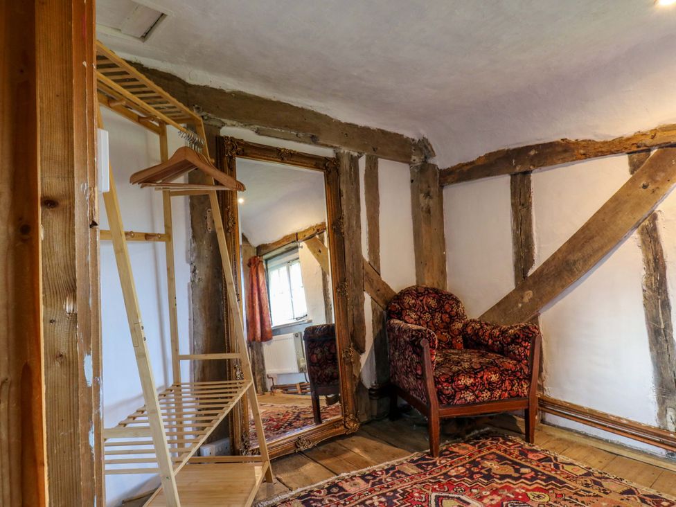 A living room with a mirror and chair at Town Farm