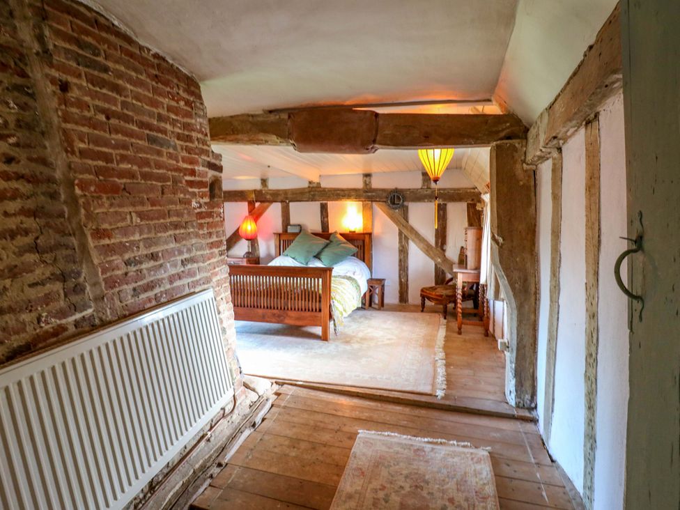 A bedroom with a bed and nightstand at Town Farm 