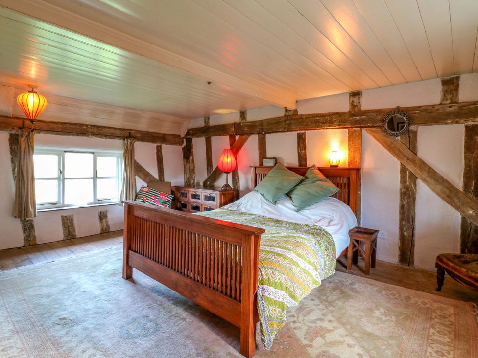 A bedroom with a bed and lamps at Town Farm