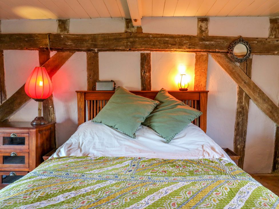 A bedroom with a bed and bedside lamp at Town Farm