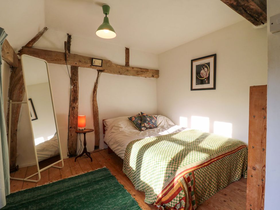 A bedroom with a bed and mirror at Town Farm in 