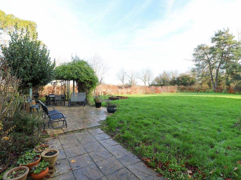A garden with a patio area and seating at Town Farm in 