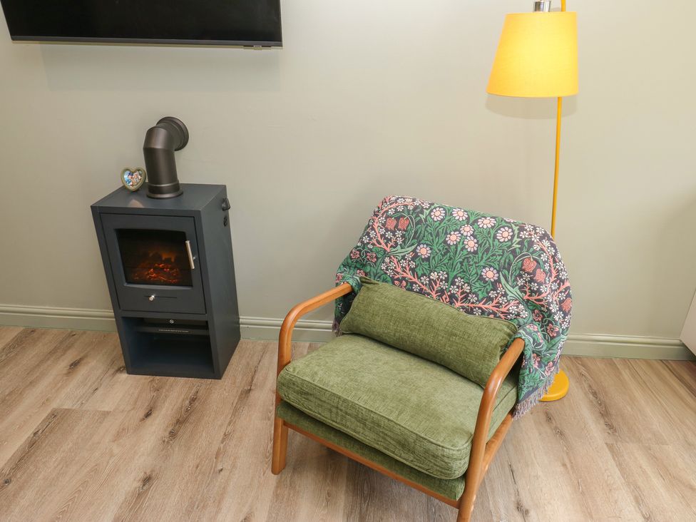 A living room with an armchair and a lamp at Underview in Jackson Bridge