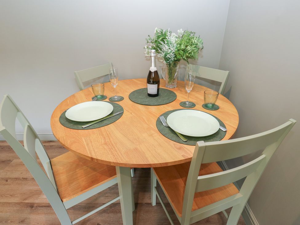 A dining room table set with a wine bottle and plates at Underview in Jackson Bridge