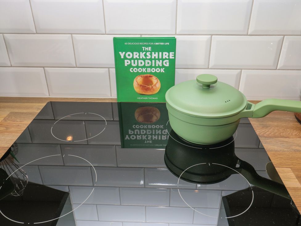 A cookbook and a green pan on a stovetop at Underview in Jackson Bridge