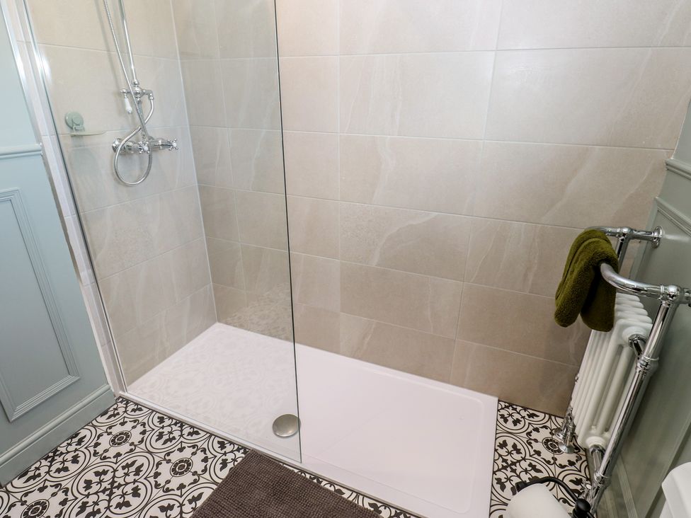 A shower with glass panel and towel rail at Underview in Jackson Bridge