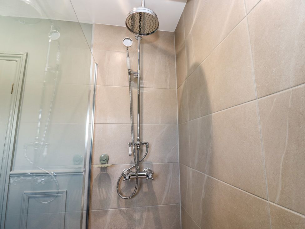 A shower area with a glass panel and chrome fixtures at Underview in Jackson Bridge