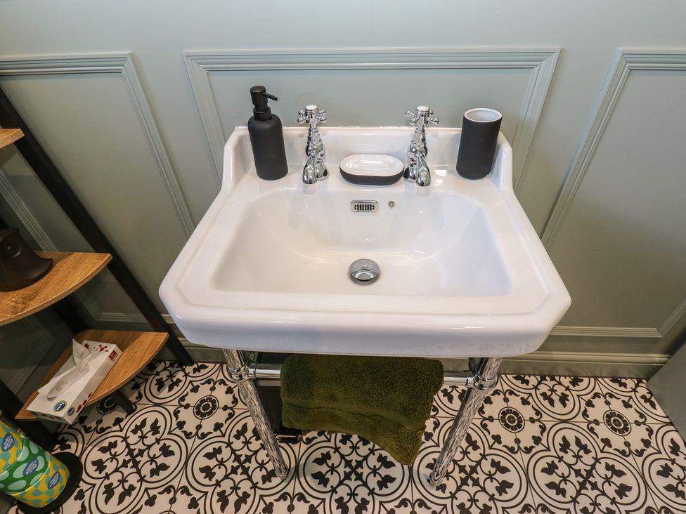 A sink with a soap dispenser and towel in the bathroom at Underview Jackson Bridge