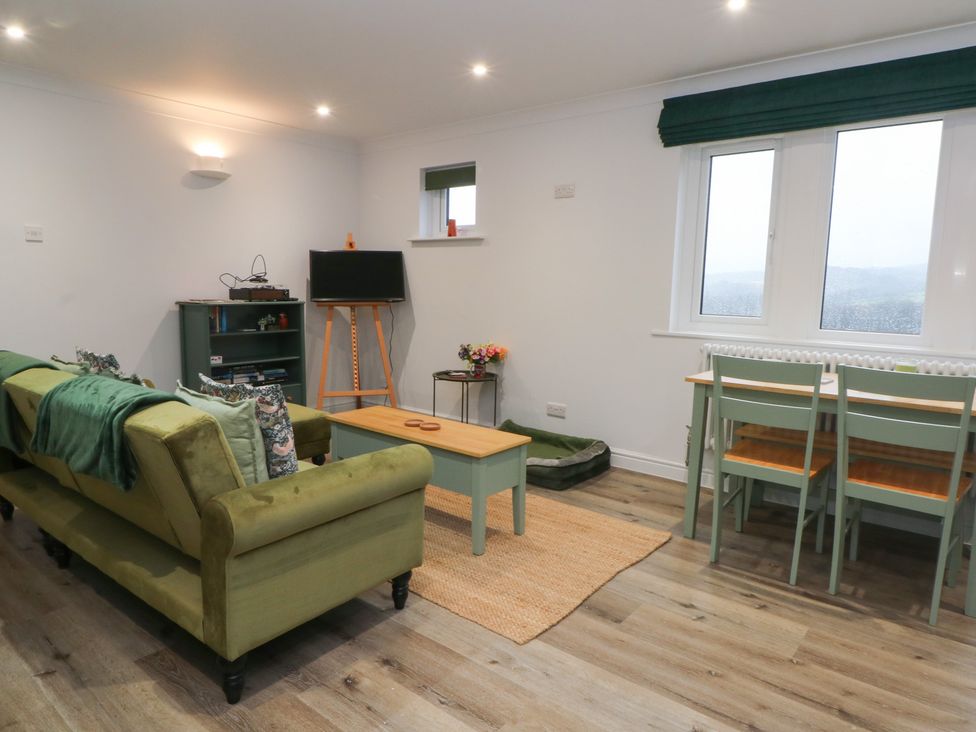 A living room with a sofa and coffee table at 4 Downshutts Lane Holmfirth