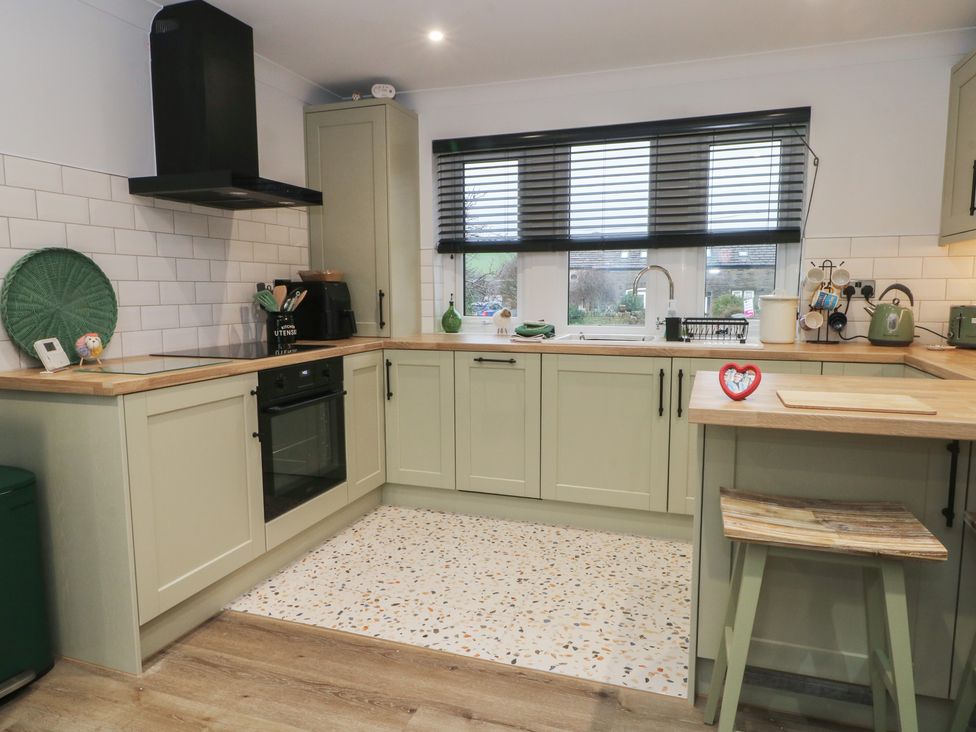 A kitchen with cabinets and a sink at 4 Downshutts Lane Holmfirth