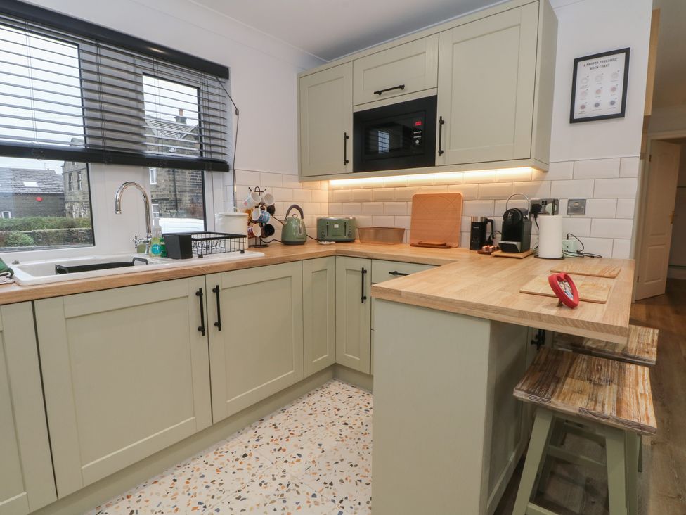 A kitchen with cabinets, sink, and appliances at 4 Downshutts Lane Holmfirth