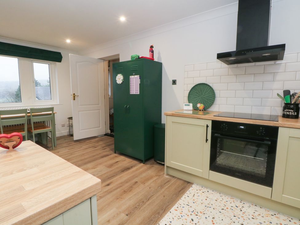 A kitchen with a green refrigerator and cabinets at 4 Downshutts Lane Holmfirth