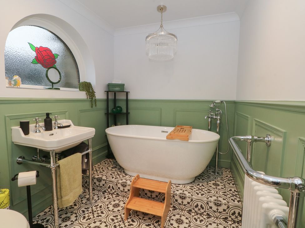 A bathroom with a freestanding bathtub and sink at 4 Downshutts Lane Holmfirth