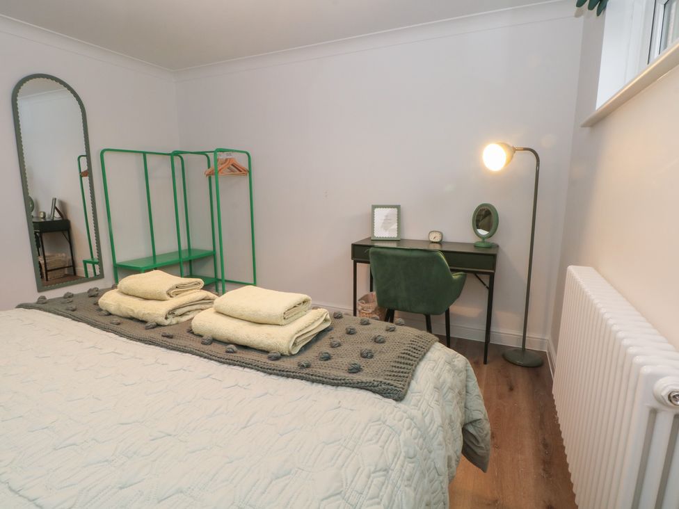 A bedroom with a bed and desk at 4 Downshutts Lane Holmfirth