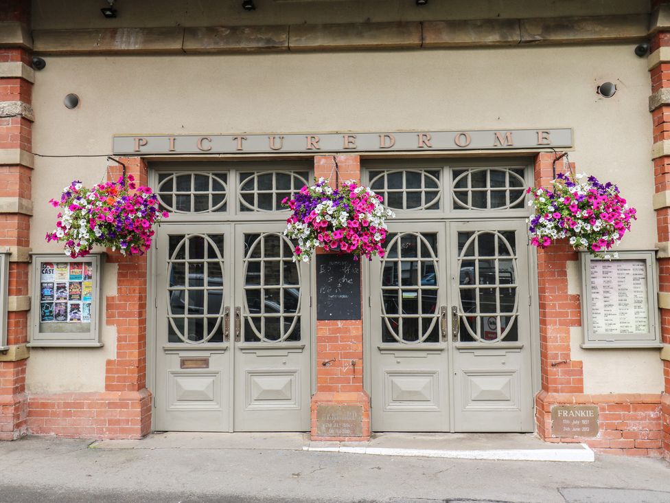 A building entrance with doors and flower baskets at Moorview in Holmfirth