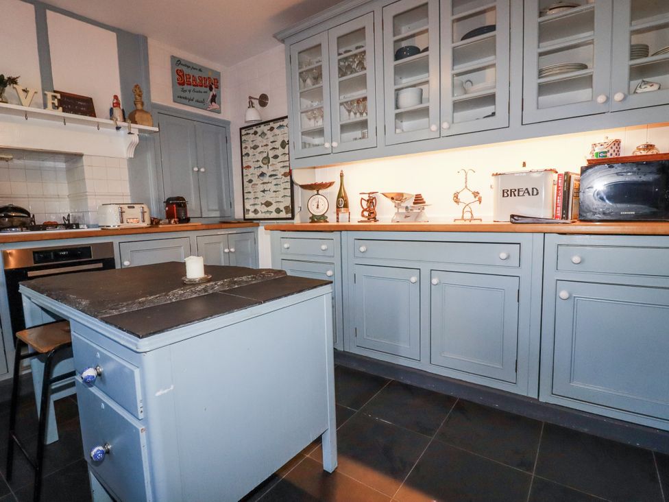 A kitchen with cabinets and an island at Rosedale in St. Ives