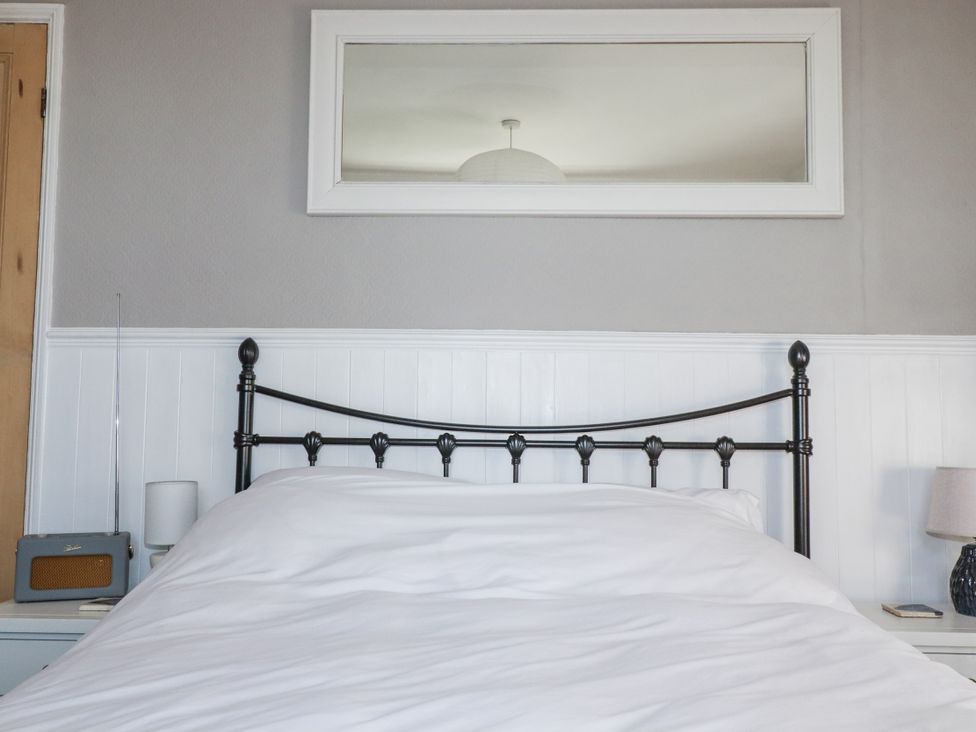 A bedroom with a bed and lamp at Rosedale in St. Ives