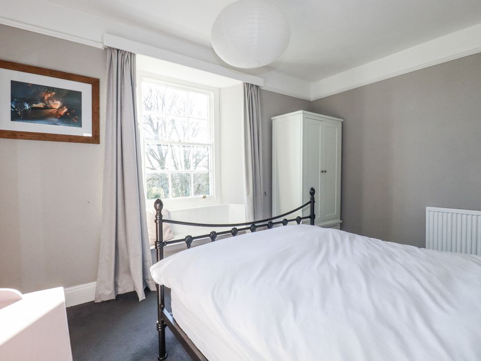A bedroom with a bed and wardrobe at Rosedale in St. Ives