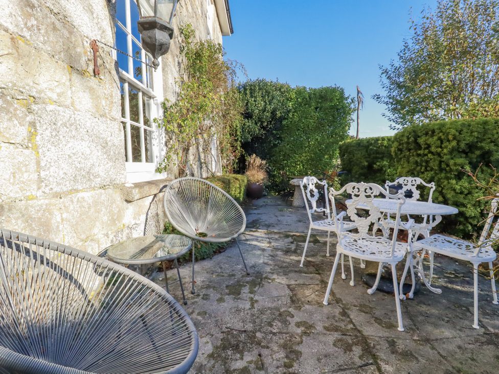 An outdoor area with chairs and a table at Rosedale in St. Ives