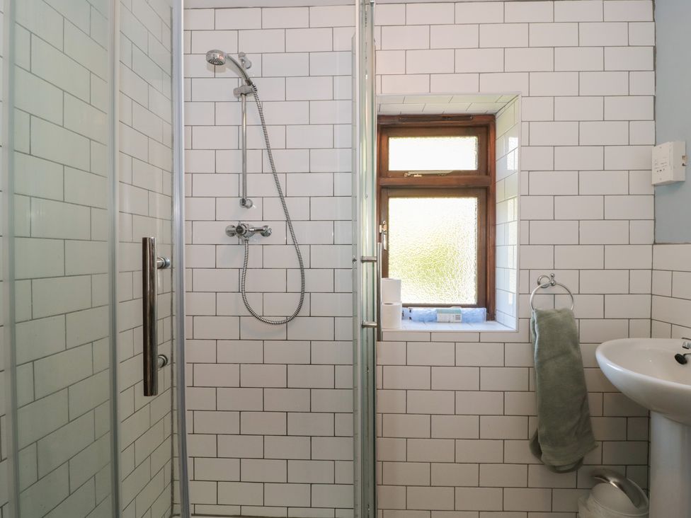 A bathroom with a shower and hand basin at The Cowshed in Bristol