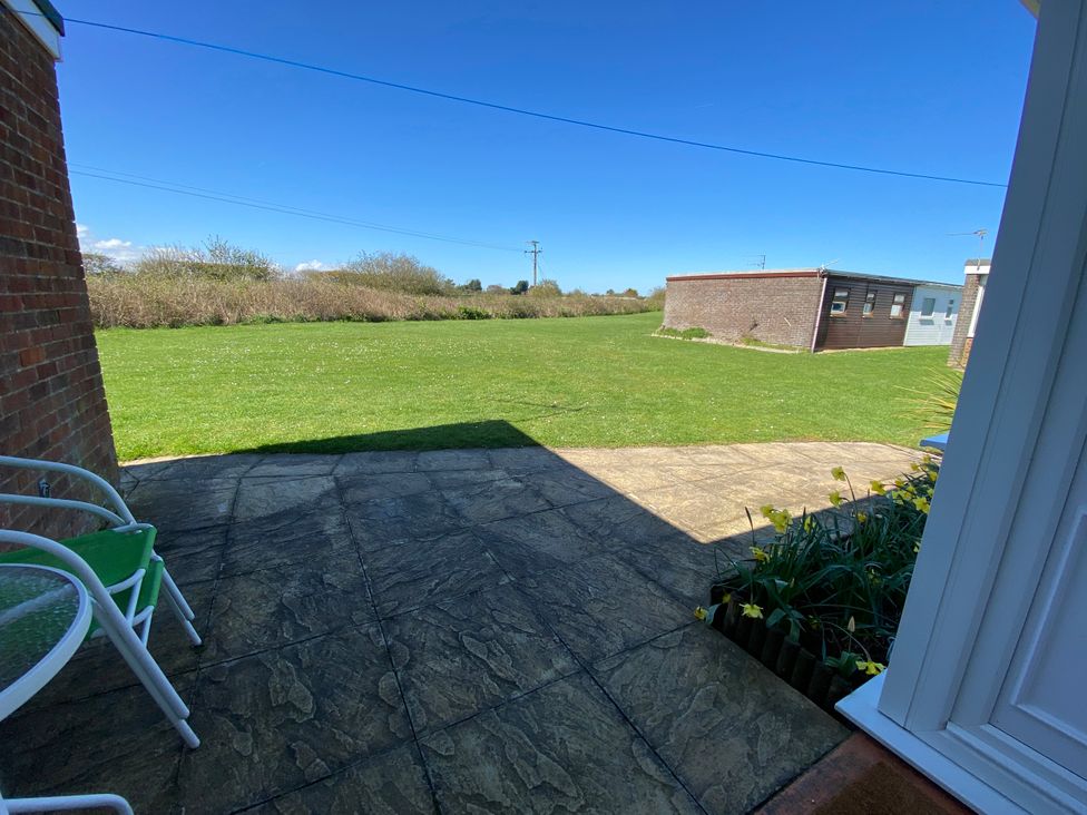 A garden with a patio and grass at 300 California Sands in California, Norfolk