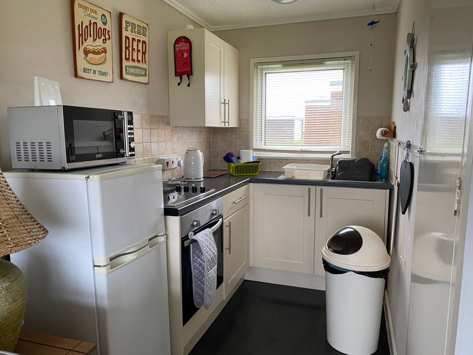 A kitchen with various appliances and cabinets at 300 California Sands, California, Norfolk