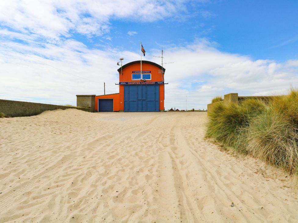 A building at the beach surrounded by sand at 300 California Sands, California, Norfolk